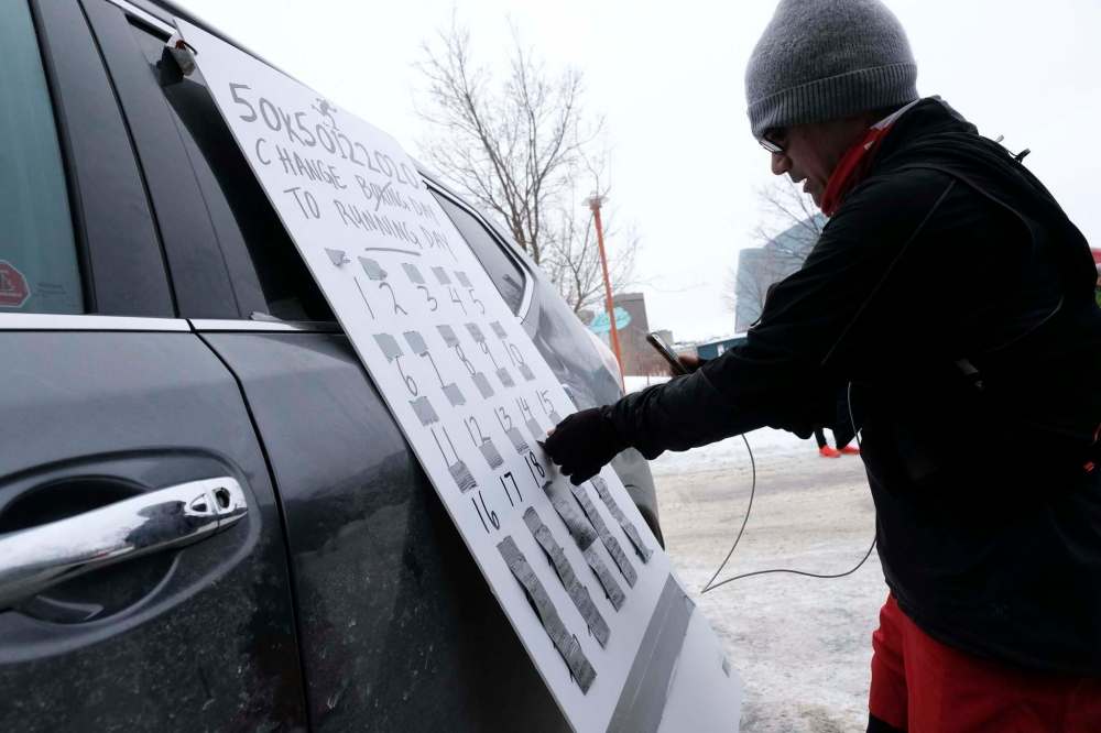Daniel Crump / Winnipeg Free Press
Junel Malapad keeps track of his laps of his 100-km ultramarathon on a board at The Forks Saturday. After each 3.3-km lap he completed, he removed a piece of tape with a motivational message on it from the board.