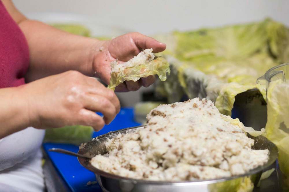 Marina Colli prepares a batch of cabbage rolls. (Mikaela MacKenzie / Winnipeg Free Press)