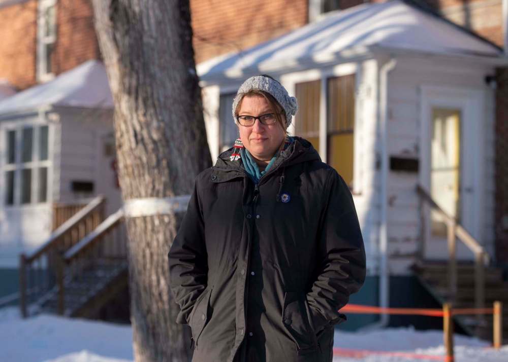 Mellanie Lawrenz of the Glenelm Neighbourhood Association tree committee, stands near a tree which was banded in 2020 to protect against Dutch elm disease. (Mike Sudoma / Winnipeg Free Press)