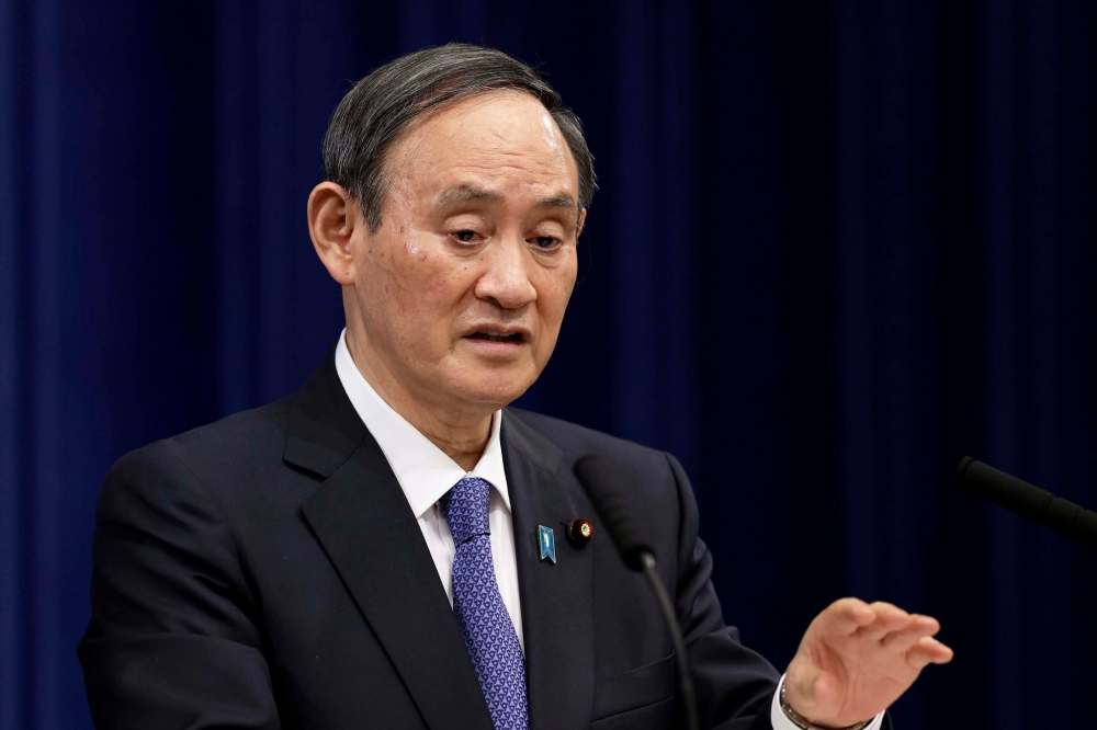Japanese Prime Minister Yoshihide Suga wants the games to go ahead no matter what. (Kiyoshi Ota / The Associated Press files)
