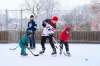 Myles Raichura (middle) plays hockey with his family at the West Broadway Community Centre on Jan. 16. (Daniel Crump / Winnipeg Free Press files)