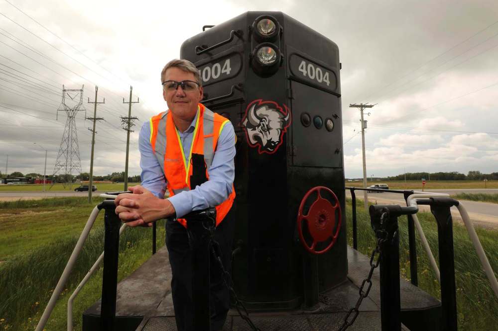 Lee Jebb, next to one of CANDO Rail Services’ trains in 2018. Jebb has stepped down from his position as chair of Prairie Mountain Health’s board of directors. (File)