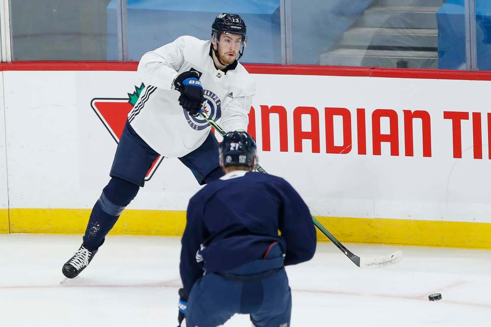 JOHN WOODS / WINNIPEG FREE PRESS
Winnipeg Jets' Pierre-Luc Dubois (13) makes the pass at practice in Winnipeg on Sunday, February 7, 2021.