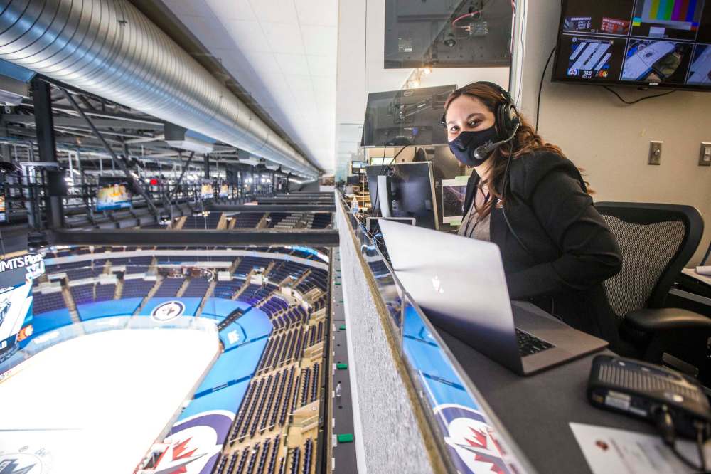 As ‘sweetener,’ Priya Plested controls crowd noises for Winnipeg Jets games from her perch high in a booth at the nearly empty Bell MTS Place. (Mikaela MacKenzie / Winnipeg Free Press)