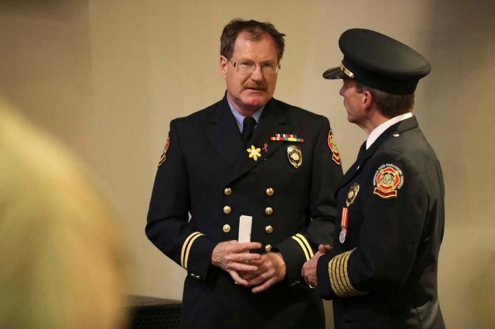 RUTH BONNEVILLE / WINNIPEG FREE PRESS United Firefighters of Winnipeg President Alex Forrest talks with Fire Paramedic Service Chief John Lane, after the graduation of Winnipeg Fire Paramedic Service Firefighter Recruit Class #1802 at The Metropolitan Entertainment Centre Friday. See Ryan Thorpe story. June 22, 2018