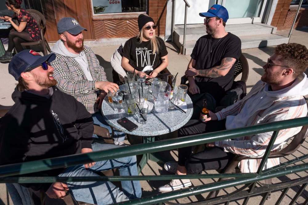Jack Syverson (left), John Sampson, Leah Dingman, Mackenzie Jackson and Matt O’Neill have some drinks as they get together on the patio at Bar Italia on Saturday afternoon. (Daniel Crump / Winnipeg Free Press)