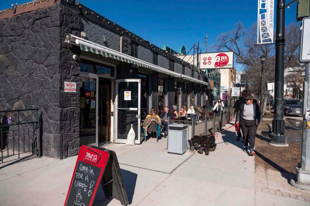 The patio at Bar Italia is full of people enjoying drinks and the company of others. (Daniel Crump / Winnipeg Free Press)
