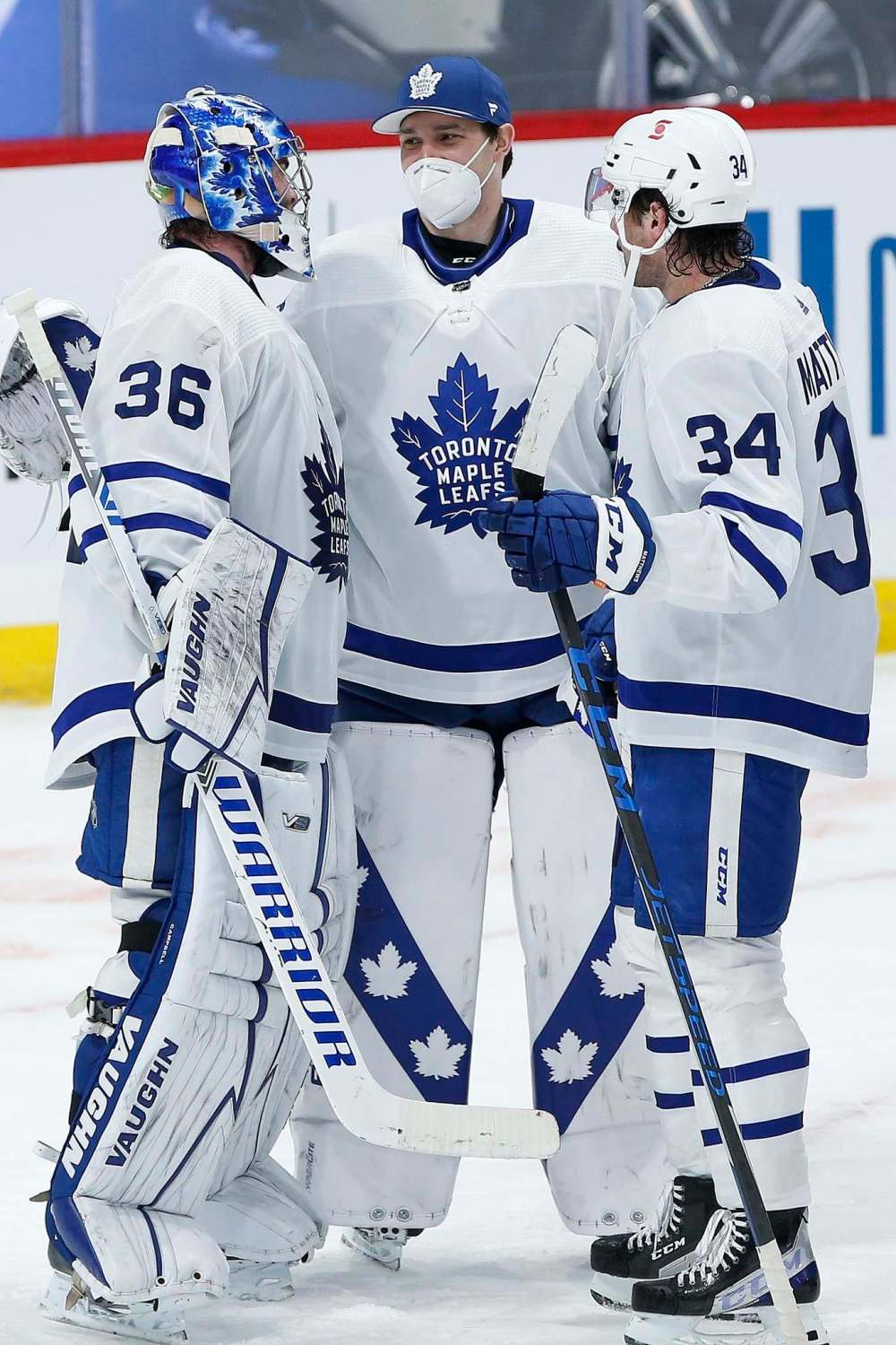 John Woods / The Canadian Press
Goaltenders Jack Campbell (36) and Hutchinson celebrate a win with Auston Matthews (34) over the Winnipeg Jets Wednesday.