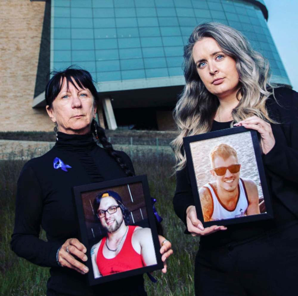 Arlene Last-Kolb (left) with a photo of her son Jessie, and Rebecca Rummery with photo of her partner Rob. (Abby Matheson photo)
