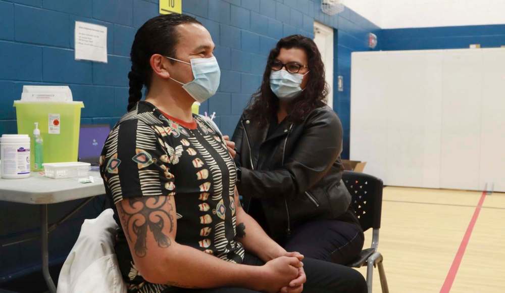 NDP leader Wab Kinew recieves a COVID-19 vaccination from Dr. Marcia Anderson, public health lead, Manitoba First Nation Pandemic Response Coordination Team, at Ma Mawi Wi Chi Itata Centre on April 29. (Supplied)