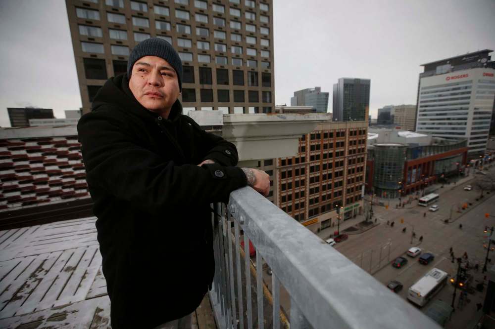 John Woods
/ The Canadian Press
Ryan Beardy, former gang member and Healing Together founder, is photographed on a rooftop in downtown Winnipeg, Monday, Dec. 2, 2019. Beardy, 35, who spent 20 years in and out of the justice system, formed the group to make a place where men can feel safe to share their feelings and support each other towards a healthier life. Many of the men discuss how they previously took part in adverse lifestyles like gangs and drugs. Now, Beardy says, they discuss how to be better men, fathers and community members.