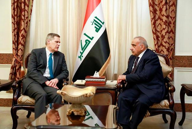 A photo released by the Iraqi Prime Minister Media Office, shows Iraqi acting Prime Minister Adil Abdul-Mahdi, right, meeting with U.S. Ambassador to Iraq Matthew Tueller at the prime minister's office, in Baghdad, Iraq, Monday, Jan. 6, 2020. (Iraqi Prime Minister Media Office, via AP)