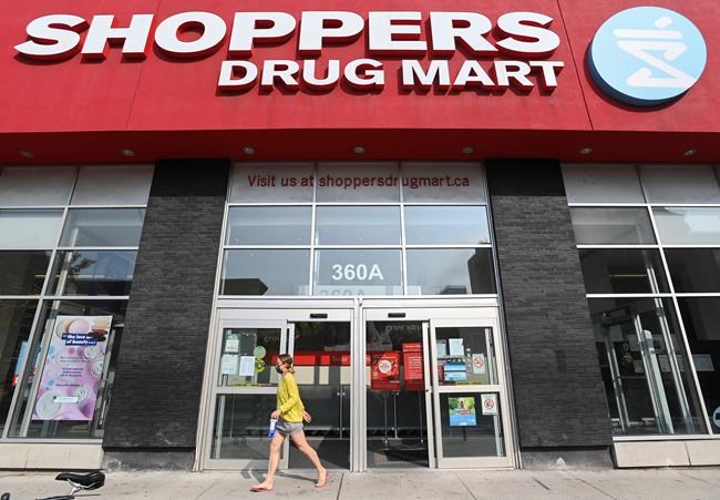 A woman leaves a Shoppers Drug Mart store where they are providing COVID-19 testing by appointment only during the COVID-19 pandemic in Toronto on Friday, September 25, 2020. THE CANADIAN PRESS/Nathan Denette