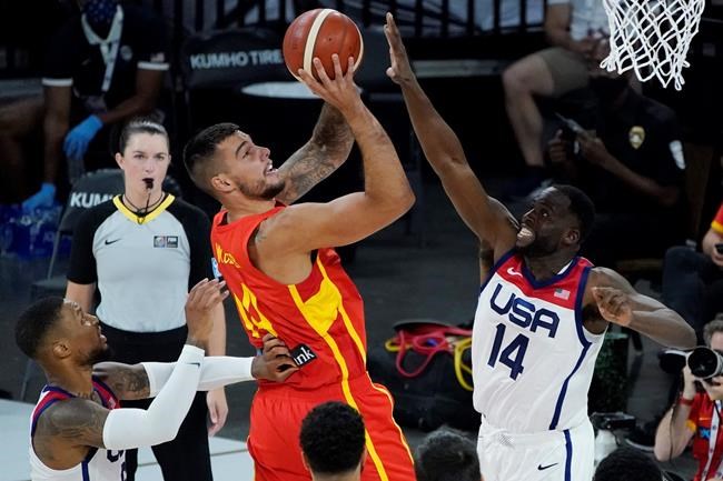 Spain's Willy Hernangomez (14) shoots against United States' Draymond Green (14) during the first half of an exhibition basketball game in preparation for the Olympics, Sunday, July 18, 2021, in Las Vegas. (AP Photo/John Locher)