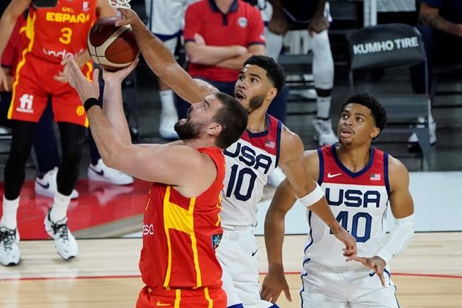 Spain's Marc Gasol (13) shoots around United States' Jayson Tatum (10) during the second half of an exhibition basketball game in preparation for the Olympics, Sunday, July 18, 2021, in Las Vegas. (AP Photo/John Locher)