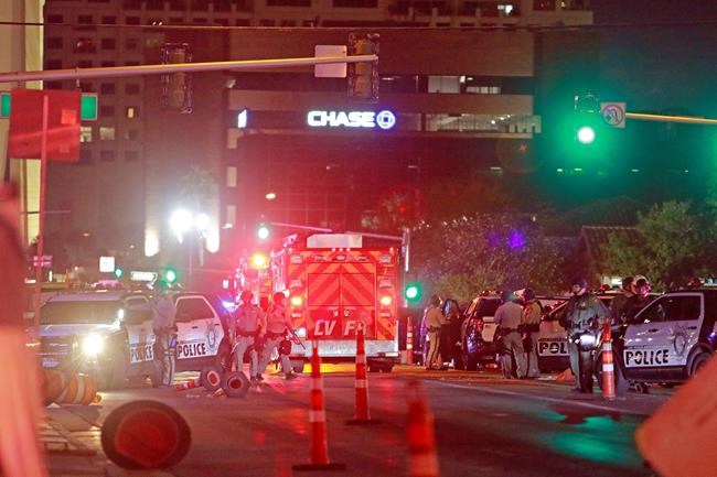 Police and rescue workers swarm the intersection outside Lloyd D. George Federal Courthouse, where shots were fired late Monday, June 1, 2020, in downtown Las Vegas. Police were present for a protest over the death of George Floyd, a Minneapolis man who died in police custody on Memorial Day. (AP Photo/Ronda Churchill)
