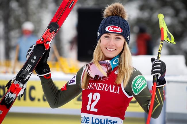 FILE - In this Dec. 7, 2019, file photo, second place finisher Mikaela Shiffrin, left, of the United States, celebrates following a women's World Cup downhill ski race in Lake Louise, Alberta. (Jeff McIntosh/The Canadian Press via AP, File)