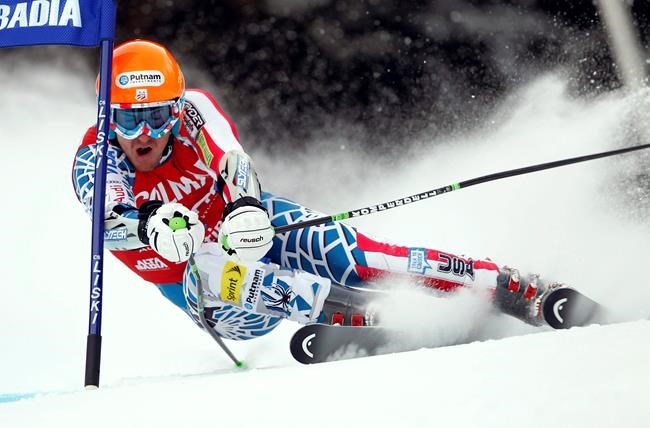 FILE - Ted Ligety of the United States passes a gate during the first run of an alpine ski men's World Cup giant slalom race, in Alta Badia, Italy, in this Sunday, Dec. 19, 2010, file photo. Two-time Olympic champion Ted Ligety says he will retire from World Cup ski racing after the world championships. Ligety’s final race will be the giant slalom on Feb. 19 in Cortina d’Ampezzo, Italy. (AP Photo/Marco Trovati, File)