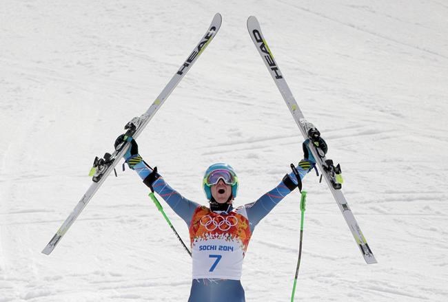 FILE - United States' Ted Ligety celebrates after winning the gold medal in the men's giant slalom at the Sochi 2014 Winter Olympics in Krasnaya Polyana, Russia, in this Wednesday, Feb. 19, 2014, file photo. Two-time Olympic champion Ted Ligety says he will retire from World Cup ski racing after the world championships. Ligety’s final race will be the giant slalom on Feb. 19 in Cortina d’Ampezzo, Italy. (AP Photo/Charlie Riedel, File)