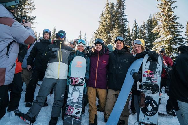 In a photo provided by Burton, Terje Haakonsen, Nicola Thost, Kelly Clark, Dave Downing and Brock Crouch, from left in front, gather Friday, Feb. 28, 2020, in Vail, Colo. Jake Burton Carpenter, whose invention of the Burton snowboard company spawned an industry that changed everything on the mountain, died in November 2019 after a relapse with testicular cancer. This was the first Burton U.S. Open since his death. (Dean Blotto Gray/Burton via AP)