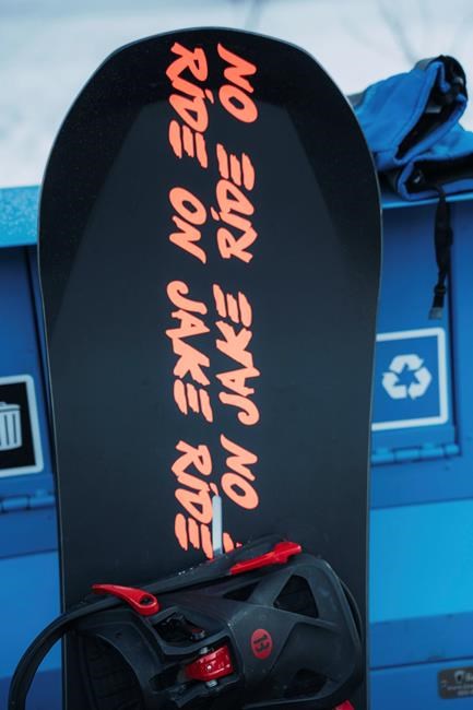 In a photo provided by Burton, a snowboard with stickers reading “Ride On Jake” sits on display before hundreds of riders honored the late Jake Burton Carpenter by taking a trip down his favorite run in Vail, Colo., Friday Feb. 28, 2020. Carpenter died in November 2019 from a relapse of testicular cancer. (Dean Blotto Gray/Burton via AP)