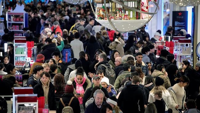 People shop at Macy's department store during Black Friday shopping, Friday Nov. 29, 2019, in New York. Black Friday shoppers fought for parking spots and traveled cross-state to their favorite malls, kicking off a shortened shopping season that intensified the mad scramble between Thanksgiving and Christmas. (AP Photo/Bebeto Matthews)