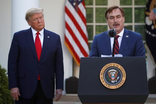 FILE - In this March 30, 2020 file photo, My Pillow CEO Mike Lindell speaks as President Donald Trump listens during a briefing about the coronavirus in the Rose Garden of the White House, in Washington. Lindell, an avid supporter of President Donald Trump, who has continued to push the notion of election fraud since Trump lost to Joe Biden in the presidential election in Novembers, said his products will no longer be carried in the stores of some retailers, including Bed Bath & Beyond and Kohl's. (AP Photo/Alex Brandon, File)