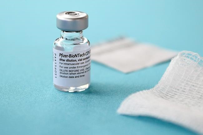 FILE - In this Monday, Dec. 14, 2020, file photo, a vial of the Pfizer-BioNTech vaccine for COVID-19 sits on a table at Hartford Hospital in Hartford, Conn. New research suggests that Pfizer’s COVID-19 vaccine can protect against a mutation found in two contagious variants of the coronavirus that erupted in Britain and South Africa. Those variants are causing global concern. They both share a common mutation called N501Y, a slight alteration on one spot of the spike protein that coats the virus. That change is believed to be the reason they can spread so easily. (AP Photo/Jessica Hill, File)