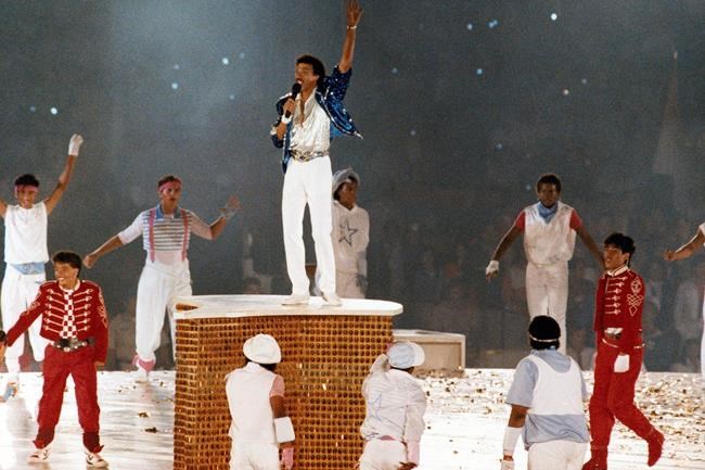 FILE - In this Aug. 12, 1984, file photo, American singer Lionel Ritchie performs during the closing ceremony of the Summer Olympics Games in Los Angeles, (AP Photo/File)