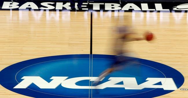 FILE - In this March 14, 2012, file photo, a player runs across the NCAA logo during practice at the NCAA tournament college basketball in Pittsburgh. The NCAA Board of Governors took the first step Tuesday, Oct. 29, 2019, toward allowing athletes to cash in on their fame, voting unanimously to clear the way for the amateur athletes to
