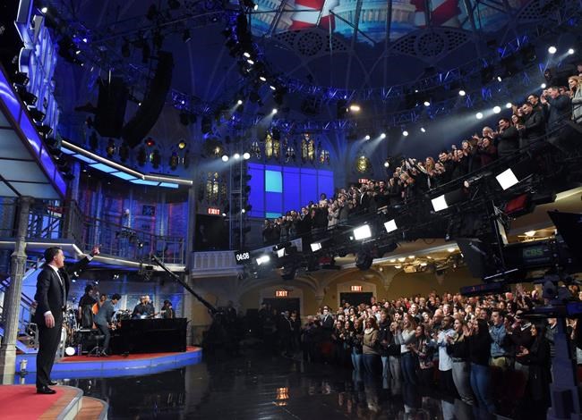 This Feb. 4, 2020 image released by CBS shows host Stephen Colbert, left, greeting the audience during a taping of