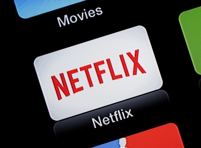 FILE - This June 24, 2015, file photo, shows the Netflix Apple TV app icon, in South Orange, N.J. Netflix reports financial results on Monday, April 18, 2016. Sports are on hold, movie theaters are closed and so are amusement parks. But Americans held captive at home by the coronavirus can turn to Netflix, Amazon, Hulu and other streaming services, outliers in an entertainment industry otherwise brought to an unprecedented standstill. (AP Photo/Dan Goodman, File)