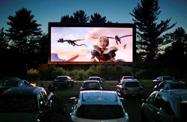 FILE - In this June 26, 2014, file photo, movie-goers watch