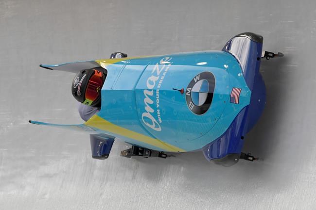 Driver Kaillie Humphries, and brakeman Lauren Gibbs of the United States take a turn during the first run of the women's bobsled World Cup race, in Lake Placid, N.Y., on Saturday, Dec. 14, 2019. (AP Photo/Hans Pennink)