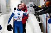 Alexander Tretiakov, of Russia, celebrates his first place finish in the men's skeleton World Cup race with fans in Lake Placid, N.Y., on Friday, Dec 13, 2019. (AP Photo/Hans Pennink)
