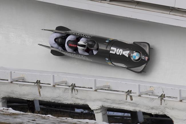 Driver Geoffrey Gadbois, Chris Avery, Michael Fogt, and brakeman Dakota Lynch, of the United States, take a turn during the second run of the four-man bobsled World Cup race, in Lake Placid, N.Y., on Saturday, Dec. 14, 2019. (AP Photo/Hans Pennink)