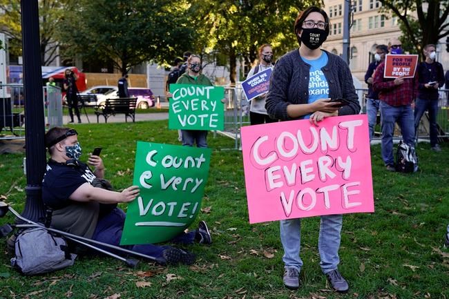 Demonstrators attend a rally in McPherson Square to support the counting of all votes the day after Election Day, Wednesday, Nov. 4, 2020, in Washington. (AP Photo/Jacquelyn Martin)