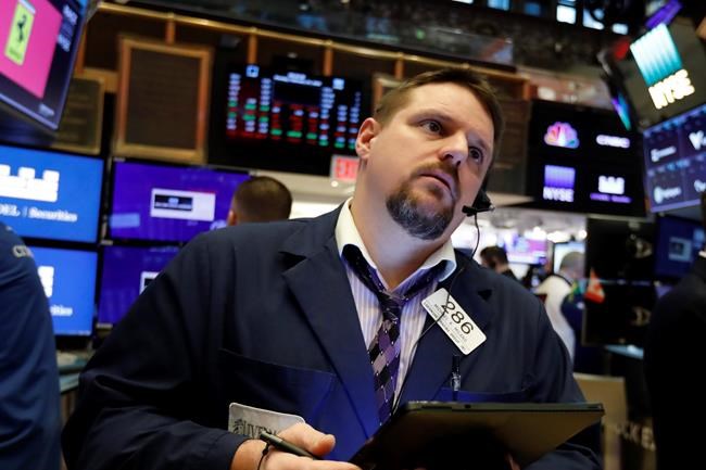 FILE - In this Feb. 24, 2020, file photo trader Michael Milano works on the floor of the New York Stock Exchange. The U.S. stock market opens at 9:30 a.m. EST on Thursday, Feb. 27. (AP Photo/Richard Drew, File)