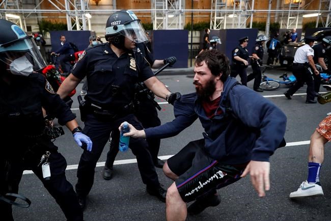 A protester is arrested for violating curfew near the Plaza Hotel on Wednesday, June 3, 2020, in the Manhattan borough of New York. Protests continued following the death of George Floyd, who died after being restrained by Minneapolis police officers on May 25. (AP Photo/John Minchillo)