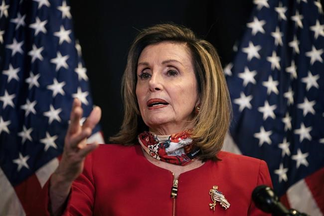 Speaker of the House Nancy Pelosi, D-Calif., talks to reporters about Election Day results in races for the House of Representatives, at Democratic National Committee headquarters in Washington, Tuesday, Nov. 3, 2020. She was joined on a video call by Rep. Cheri Bustos, D-Ill., chairwoman of the Democratic Congressional Campaign Committee. (Alyssa Schukar/The New York Times via AP, Pool)