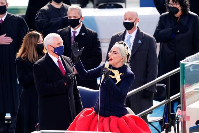 Lady Gaga sings the National Anthem during the 59th Presidential Inauguration at the U.S. Capitol for President-elect Joe Biden in Washington, Wednesday, Jan. 20, 2021. Former Vice President Mike Pence is on left. (Kevin Dietsch/Pool Photo via AP)