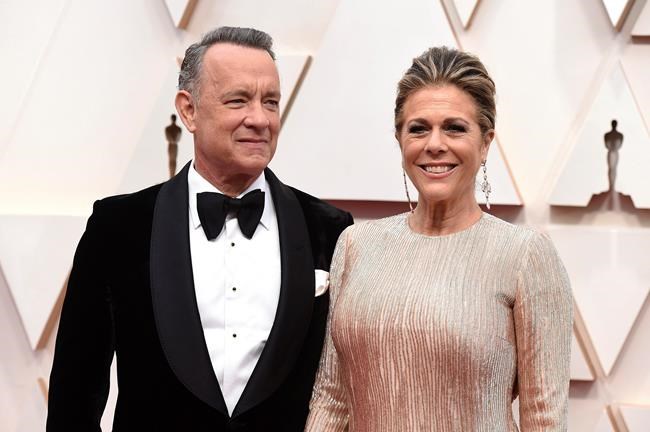 FILE - In this Feb. 9, 2020 file photo, Tom Hanks, left, and Rita Wilson arrive at the Oscars at the Dolby Theatre in Los Angeles. The couple have tested positive for the coronavirus, the actor said in a statement Wednesday, March 11. The 63-year-old actor said they will be