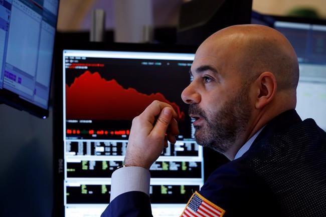 Trader Fred DeMarco works on the floor of the New York Stock Exchange, Friday, Feb. 28, 2020. Global stock markets are falling further on spreading virus fears. (AP Photo/Richard Drew)