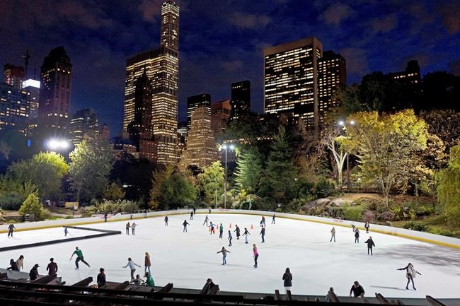 FILE - In this Nov. 3, 2016 file photo, skaters take to the ice at Wollman Rink in New York's Central Park. New York City will terminate business contracts with President Donald Trump after last week's insurrection at the U.S. Capitol. Mayor Bill de Blasio announced Wednesday, Jan. 13, 2021, the Trump Organization is under city contract to operate the two ice rinks and a carousel in Central Park as well as a golf course in the Bronx. (AP Photo/Mark Lennihan, File)