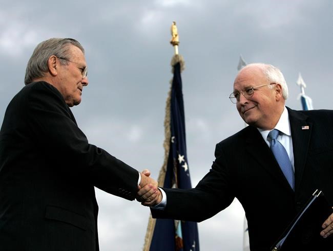 FILE - In this Dec. 15, 2006, file photo, outgoing Defense Secretary Donald H. Rumsfeld, left, shakes hands with Vice President Dick Cheney during an Armed Forces Full Honor Review for Rumsfeld at the Pentagon. All 10 living former secretaries of defense, including Rumsfeld and Cheney, have joined in cautioning against any attempt to use the military in the cause of overturning the November 2020 presidential election. (AP Photo/Pablo Martinez Monsivais, File)