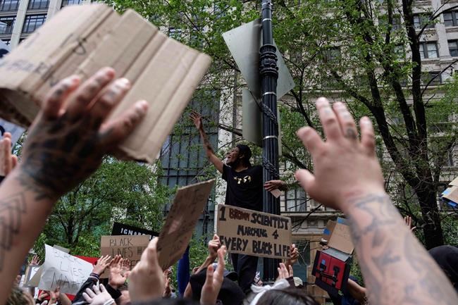 Protesters raise their hands near Foley Square on Tuesday, June 2, 2020, in New York, as part of a demonstration against police brutality sparked by the death of George Floyd, a black man who died after being restrained by Minneapolis police officers on May 25. (AP Photo/Yuki Iwamura)