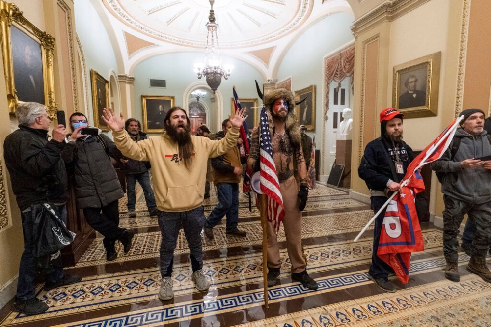 Jake Angeli, known as the QAnon Shaman, with other Donald Trump supporters inside the Capitol building on Wednesday. (Manuel Balce Ceneta / The Associated Press files)