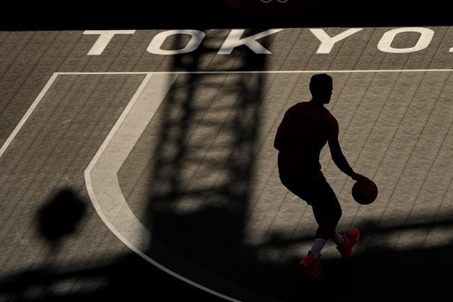 An athlete from Belgium practices for the 3x3 basketball competition at the 2020 Summer Olympics, Wednesday, July 21, 2021, at the Aomi Urban Sports Park in Tokyo. (AP Photo/Charlie Riedel)