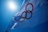 An Olympic flag flies over the top of the bleachers at Ariake Tennis Center, Monday, July 19, 2021, in Tokyo. (AP Photo/Kiichiro Sato)