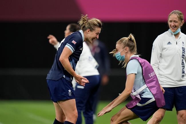 Britain's Ellen White, left, celebrates with teammates after scoring her side's opening goal against Chile during a women's soccer match at the 2020 Summer Olympics, Wednesday, July 21, 2021, in Sapporo, Japan. (AP Photo/Silvia Izquierdo)
